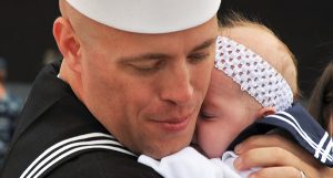 A military dad hugging his baby.