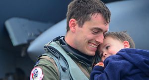 A military dad hugging his child.