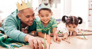 A dad playing with his kids.