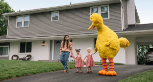Big Bird and a family holding hands.