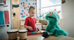 Rosita and a child playing an instrument.