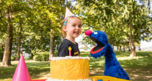 Child and Grover at a birthday party