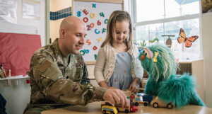 Rosita with a child and Dad in a waiting room.